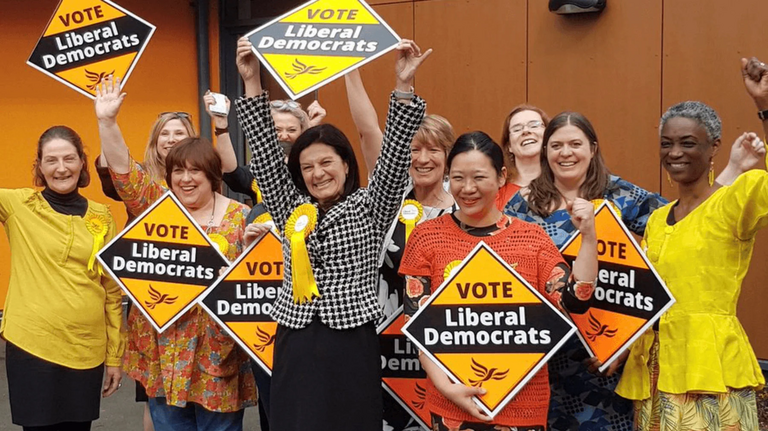 South Cambridgeshire A group of Liberal Democrats holding signs and celebrating winning