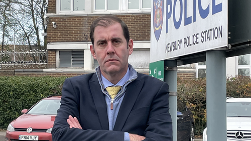 Lee standing outside the police station