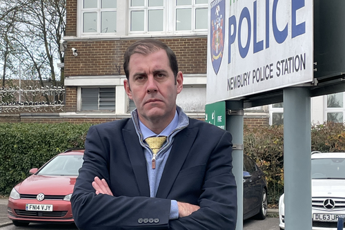 Lee standing outside the police station