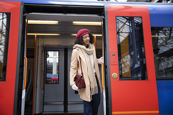 Woman stood in open train doorway