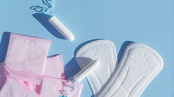 Photo of sanitary pads and tampons on a blue background