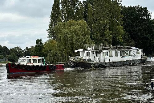 Photo of illegally moored boat being towed.