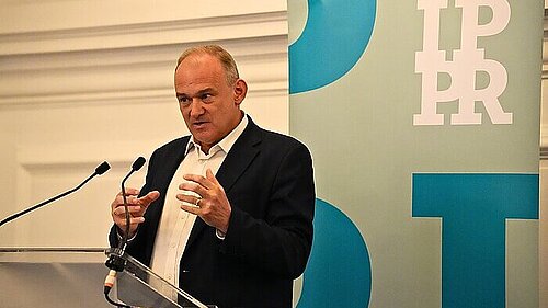 Ed Davey presenting plans to half energy bills