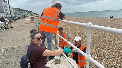 Volunteers painting seafront railings in Sandgate