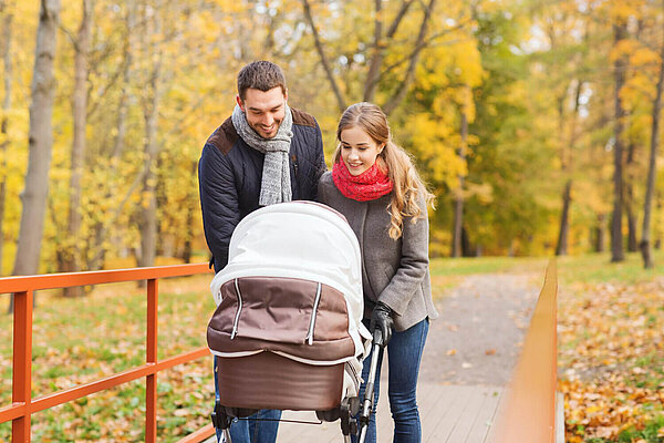 Two people looking into a pram