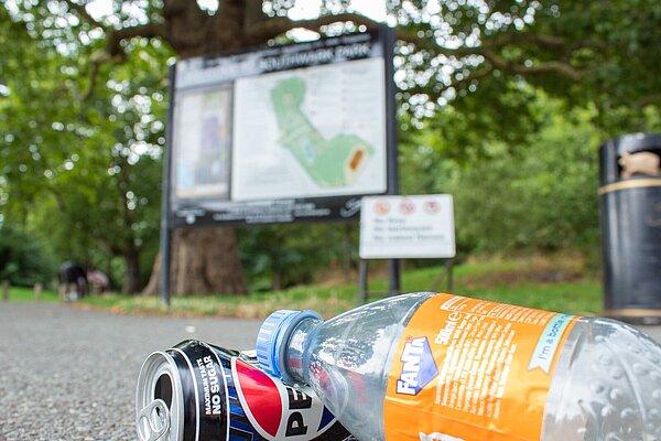 empty drinks containers littered on the floor of Southwark park