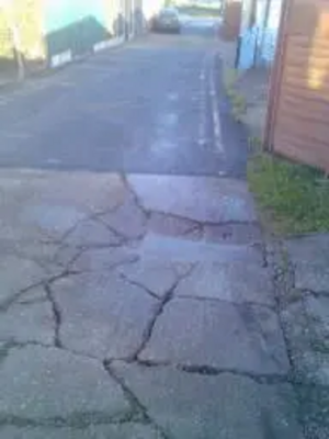 Cracked and potholed lane
