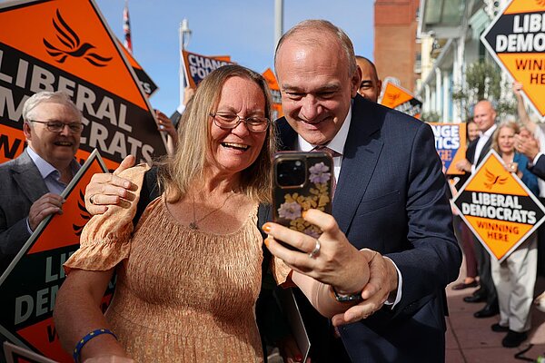 Ed Davey with a party member at a rally