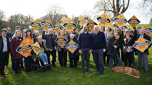 Josh Babarinde MP and Ed Davey MP with a crowd of activists in Eastbourne