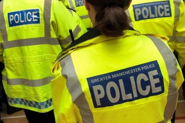 Image showing the backs of Greater Manchester Police Officers in high-vis jackets