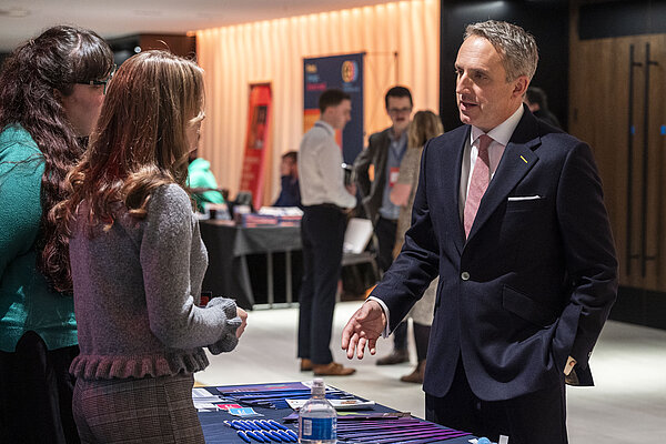 Alex Cole-Hamilton speaking to an exhibitor at Scottish Lib Dem conference