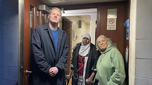 Cllr Ben Curtis (left), Amino Mahdi (centre), and Sue Woody (right) in front of Selby House, Oaklands Estate.  