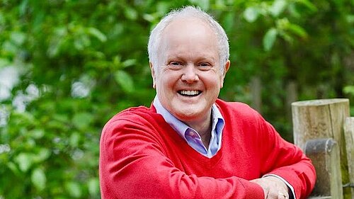 Clive outside by a fence