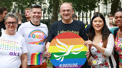 Ed Davey with fellow Liberal Democrats at pride holding a Lib Dem pride poster