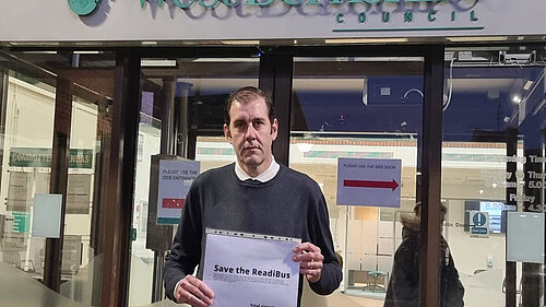 Cllr Lee Dillon with the ReadiBus petition outside West Berkshire Council offices