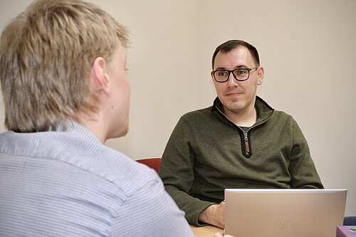 Tom sat talking to a constituent