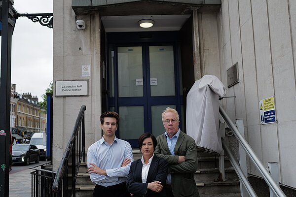 Three Wandsworth Liberal Democrat campaigners standing on the steps of the Lavender Hill police station