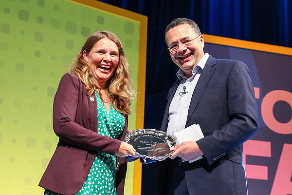 Vikki Slade receives an award from Party President Mark Pack