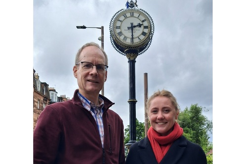 Councillor Neil Ross and Anna Aitken standing in front of the Morningside clock