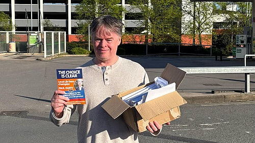 Paul Duffy carrying leaflets