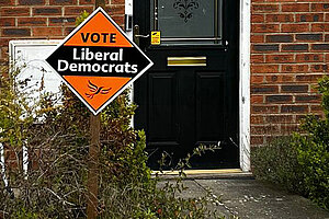 Image of Lib Dem Garden Poster infront of black door