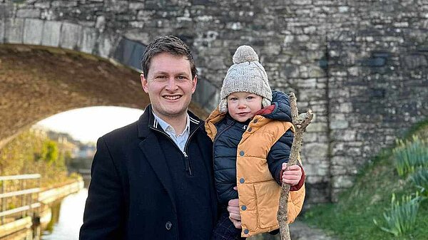 David Chadwick standing with his son in front of Brecon Canal