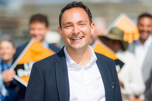 Image of Blaise with activists holding Lib Dem diamonds in the background