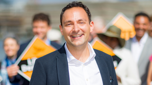 Image of Blaise with activists holding Lib Dem diamonds in the background