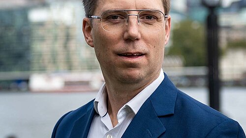 Rob Blackie pictured with a white shirt and navy blazer.