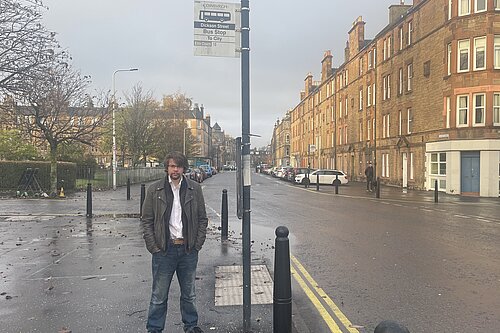 Jack Caldwell standing at a bus stop in Dalmeny Street