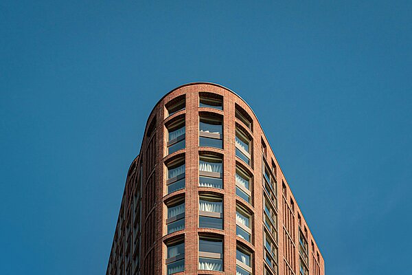 A block of flats against a blue sky
