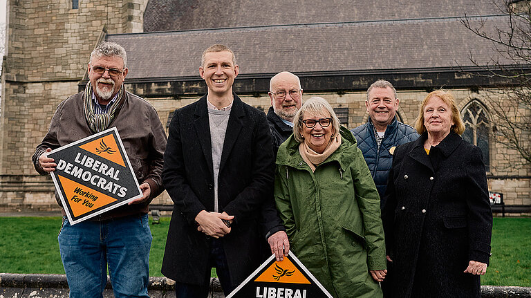 The Senedd 2026 list candidates for Clwyd smiling in front of the church in St. Asaph