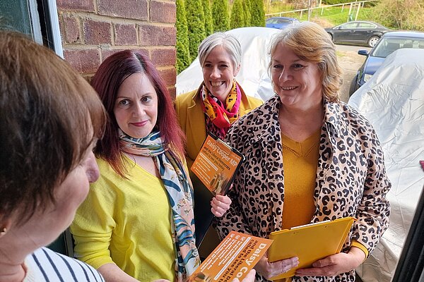 Lynn Cunningham on doorstep with Daisy Cooper MP and Sinead Howland