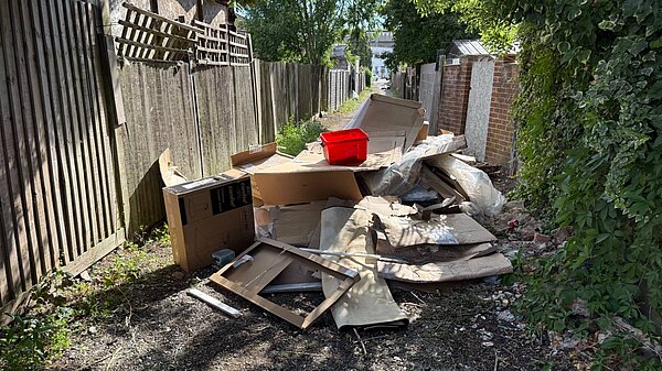 A red plastic box on a pile of rubbish