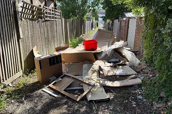 A red plastic box on a pile of rubbish