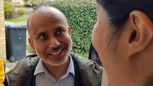 Sarwar Shashmer speaking to a resident 