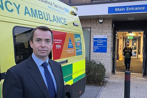 Calum Miller standing next to an emergency ambulance outside Bicester Hospital
