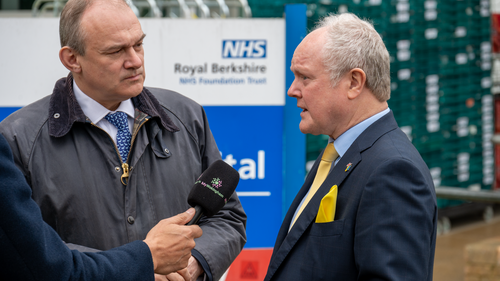 Clive and Ed Davey outside the RBH. Clive is talking into a reporter's microphone