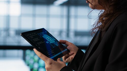 Someone holding a tablet using an AI chatbot