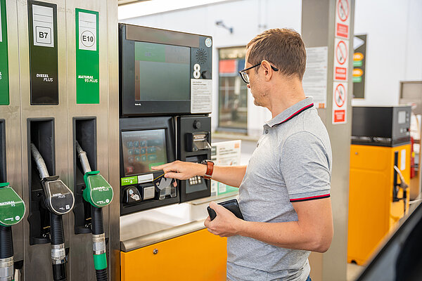 man pays for fuel at the pump