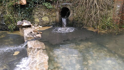 Sewage being discharged into a river.