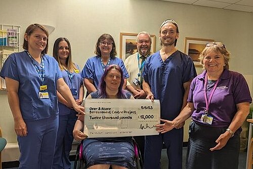 Image off Cllr. Helen Walker presenting cheque for £12,000 to membes of North Devon District Hospital Over-and-Above team.