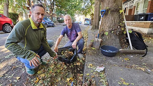 Councillor Gary Malcolm cleaning the streets with local resident John Eklof.