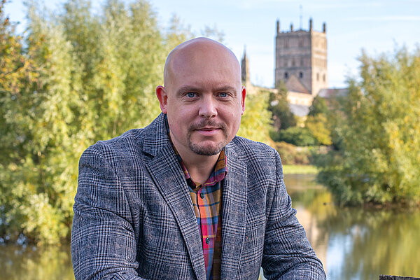 Cameron Thomas in front of Tewkesbury Abbey