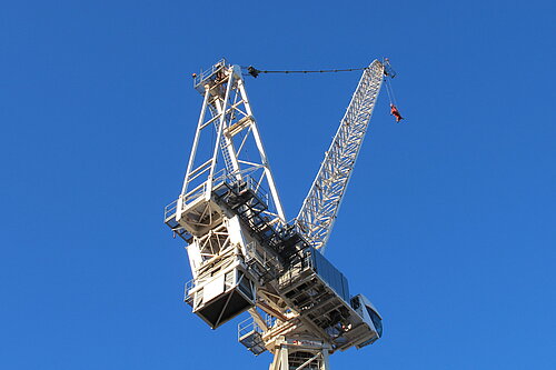 A crane with blue sky in the background