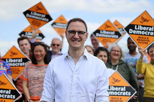 Ian Sollom with volunteers in the background