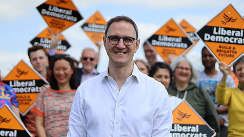 Ian Sollom with volunteers in the background