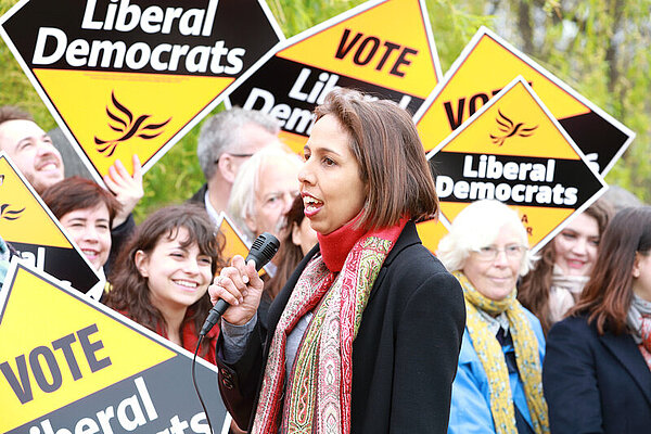 LibDem standing in front of LibDem signs
