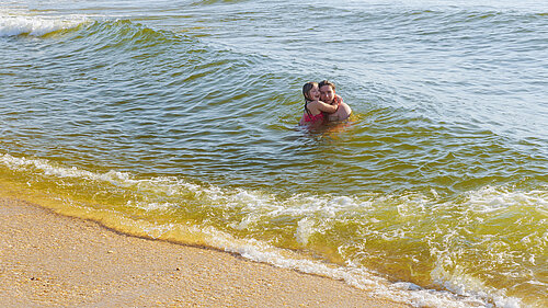 Two young people swimming in the sea