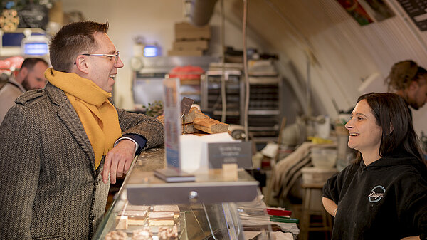 Rob Blackie speaking to a bakery owner